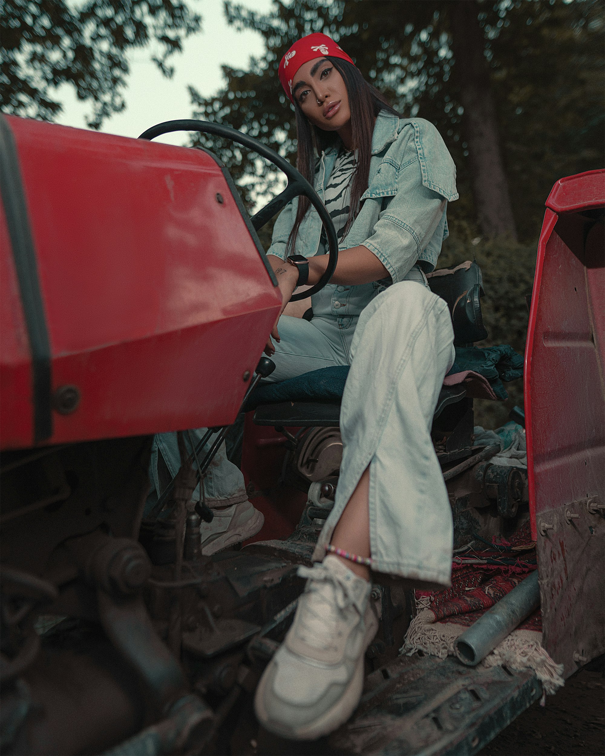 man in brown and green camouflage uniform sitting on red tractor during daytime